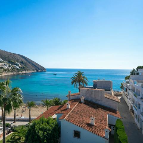 Flip-flop down to the sandy shores of El Portet Bay, just moments from your door