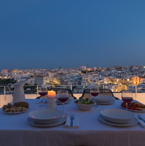 Enjoy a delicious meal outside on the terrace and gaze across the city at dusk