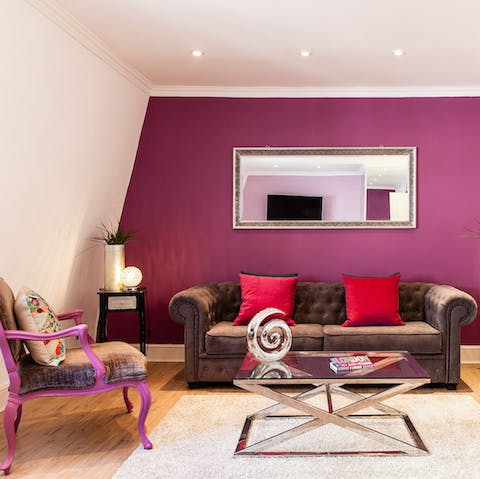 Unwind after a busy day in the bold living area, feeling as cheery as the paint on the wall