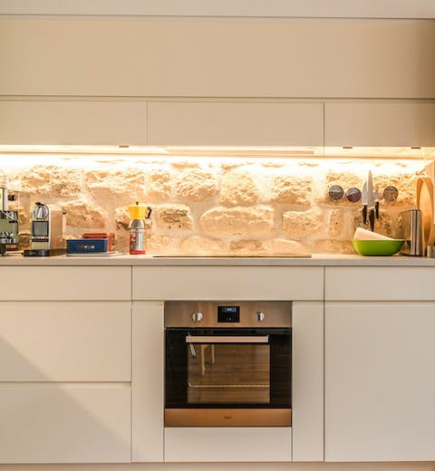 The exposed stone wall in the kitchen