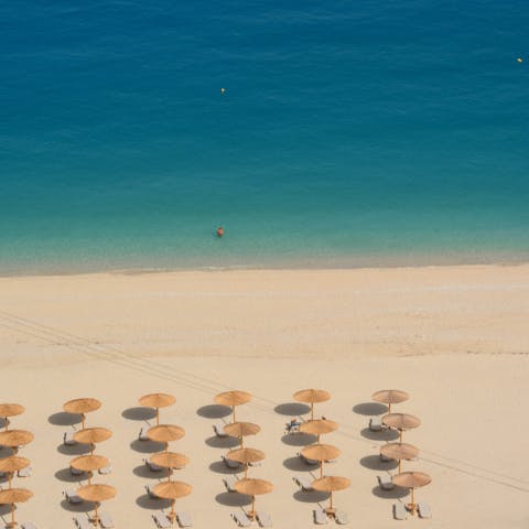 Spend time relaxing on Lourdas beach, just a ten-minute drive from the villa