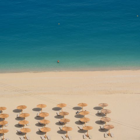 Spend time relaxing on Lourdas beach, just a ten-minute drive from the villa