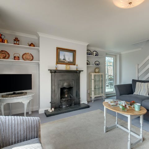 Gather guests together in the living room and get cosy around the fireplace