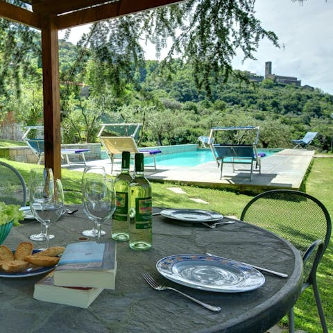 Watch the sun set over the Tuscan hills from the garden pergola