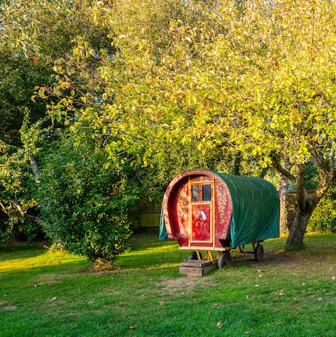 Let the kids play in the whimsical caravan at the bottom of the garden
