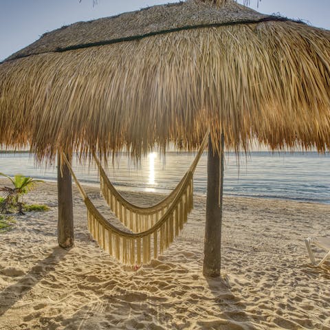 Rock yourself to sleep in the beachfront hammock