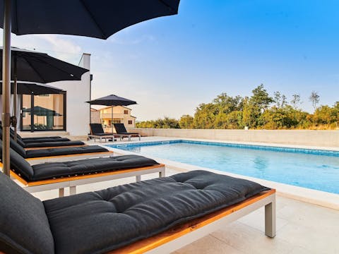 Put your feet up as you relax on the sun loungers by the pool
