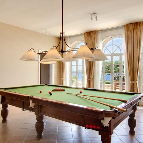 Gather friends and family for a pool tournament on the antique billiards table 