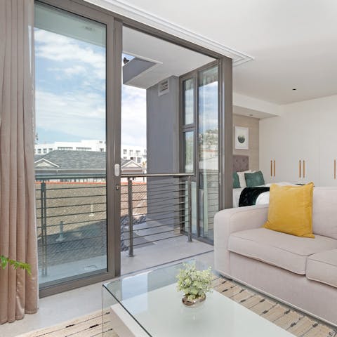 Step out onto the balcony from this elegant living space