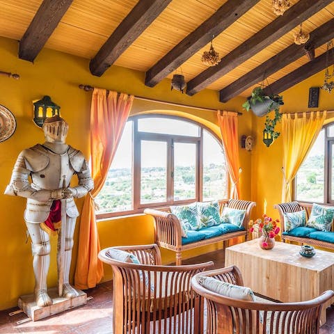 Relax in a characterful living room, with a suit of armour and pool table
