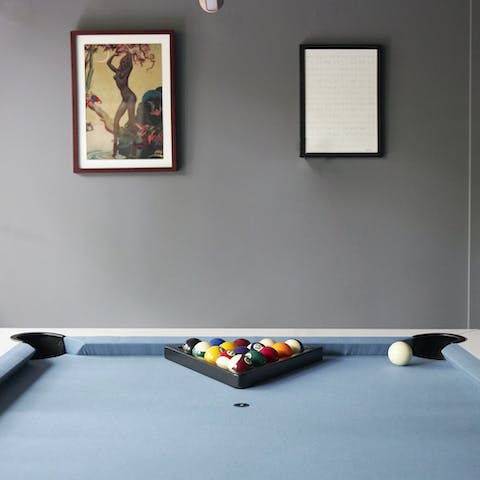 Set up a game of pool in the games room