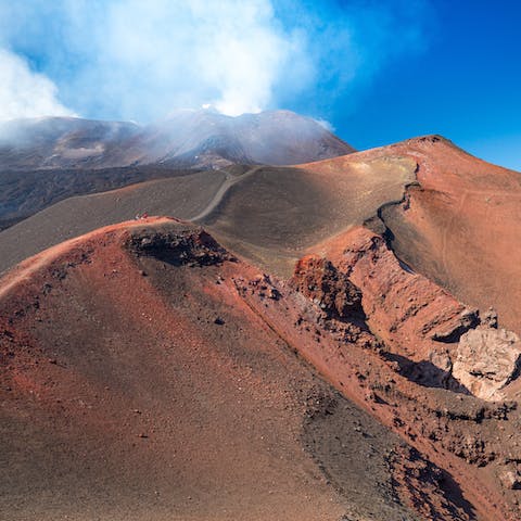 Hike along the peaks of Mount Etna Park, which sits five minutes' walk from the home