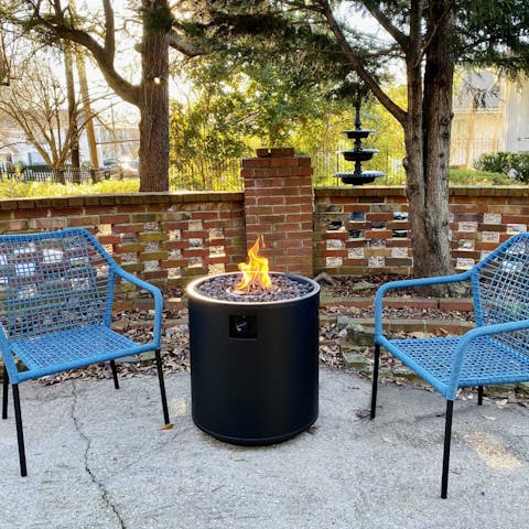 Gather around the crackling outdoor fireplace at sunset