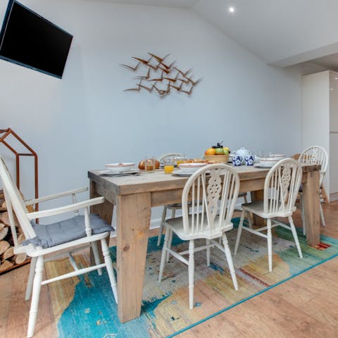 Enjoy big dinners at the dining table made from recycled wood