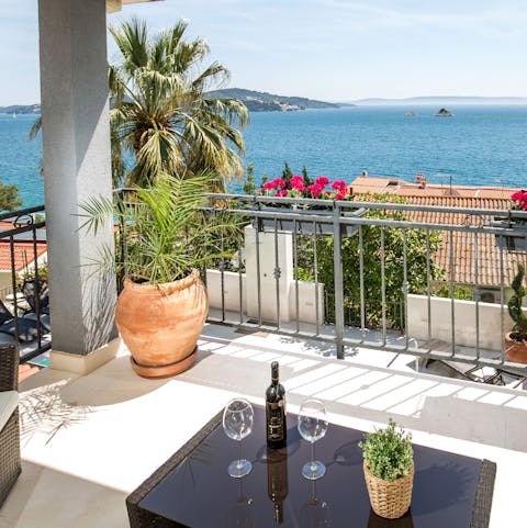 Enjoy a glass of Rosé from your private balcony overlooking the Adriatic Sea