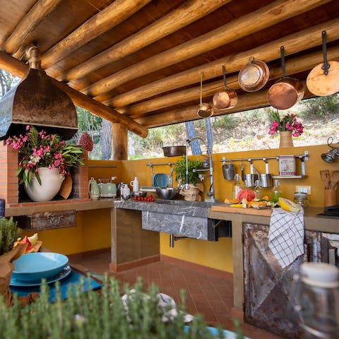 Work culinary magic in the outdoor kitchen and serve up to guests on the terrace