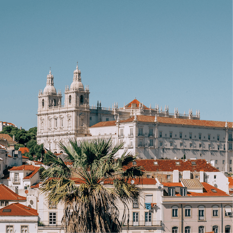 Explore the atmospheric streets of Alfama, a fifteen-minute drive away