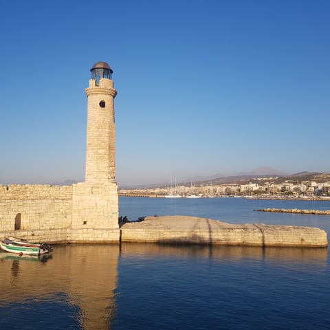 Drive up to Rethymno and dine by the lighthouse on the harbour