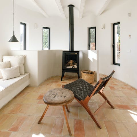 Gather around the wood burner fireplace with a glass of wine in the evenings