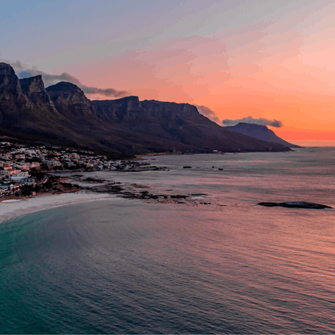 Stroll along Camps Bay Beach at sunset, it's a ten-minute walk away