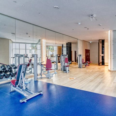 Start a new fitness routine in the building's shared gym
