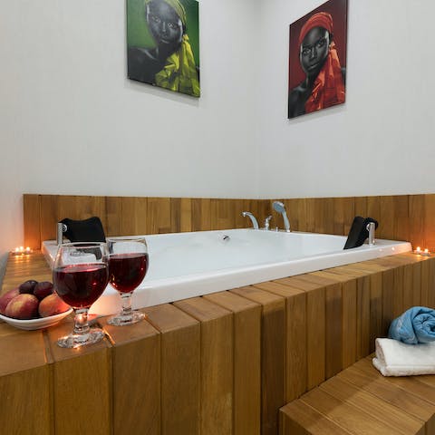 Soak in the hot tub, set in the bedroom, with a delicious glass of red