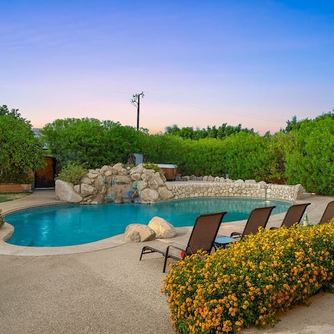 Relax under the pool's built-in waterfall feature