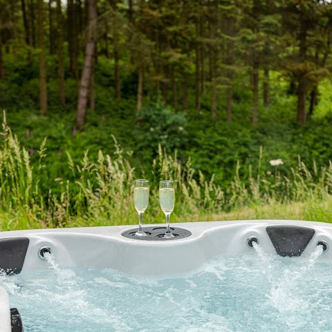 Enjoy a peaceful moment – and a cool glass of English fizz – in the private hot tub