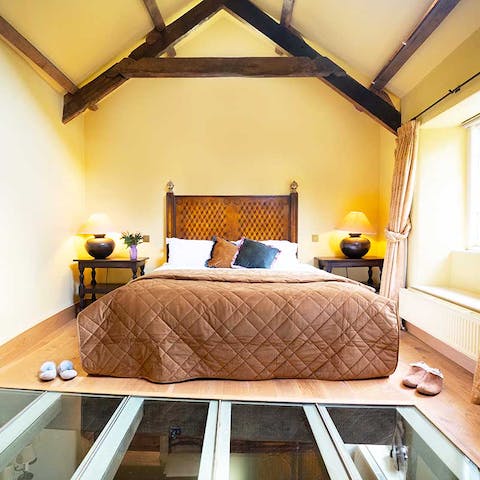 Look down into the living room through the unique glass floor