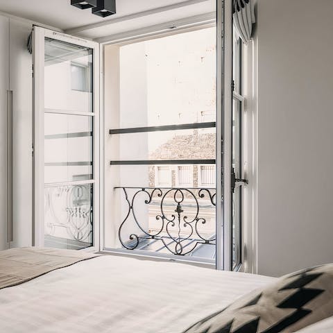 Wake up to Parisian rooftops views from the bedrooms' Juliet balconies