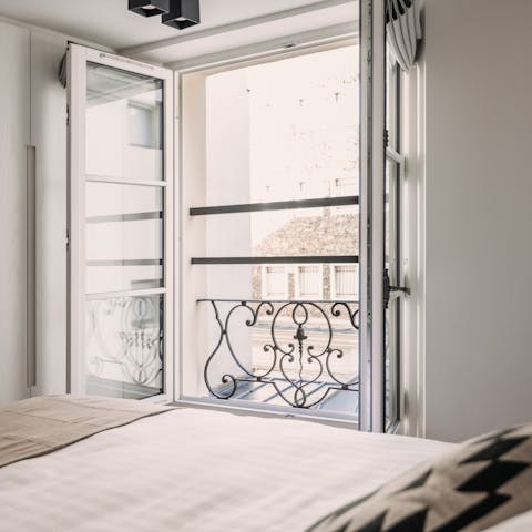 Wake up to Parisian rooftops views from the bedrooms' Juliet balconies