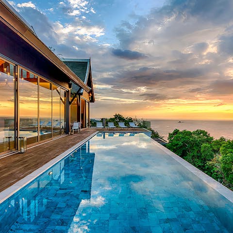 Watch the sun plunge into the Andaman Sea as you bob about in the pool