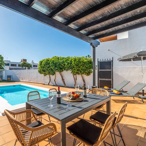 Try some of the local food and wine beneath the pergola