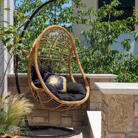 Read a book in the swinging egg chair, after a morning of wandering the quaint streets of Koutsouras