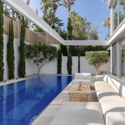 Sip on a glass of red by the sparkling pool