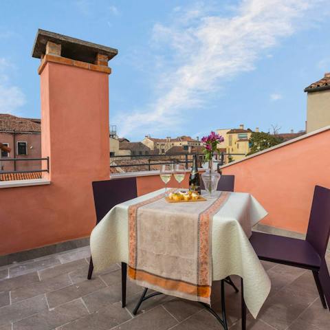 Enjoy dinner under the setting sun on the apartment's rooftop terrace