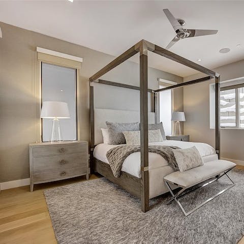 Slumber in total luxury in the modern, four-poster bed