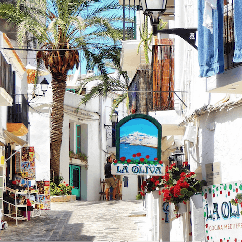 Stroll along the cobbled streets of Ibiza's old town – a twenty–minute drive away