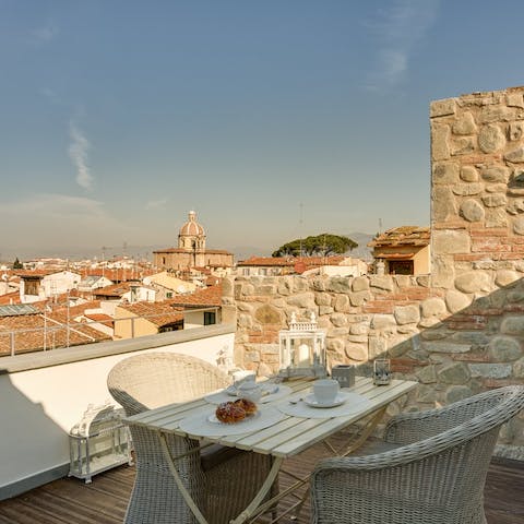 Dine alfresco on the rooftop terrace with sweeping views of  Florence