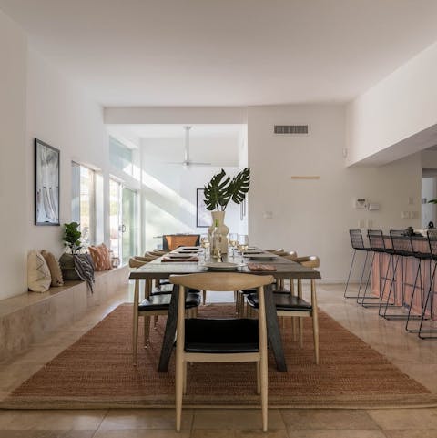 Gather the group at the long, stylish dining table