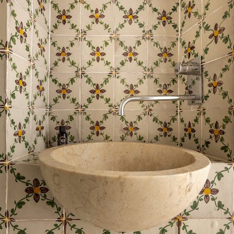 Admire the painted tiles in the bathroom