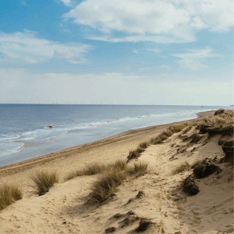 Sink your feet into the sand at Cromer beach, a short drive away