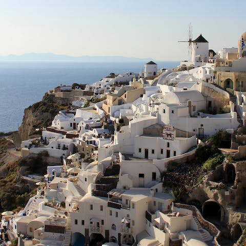 Wind your way through the stunning streets of Oia - stopping to admire the views along the way