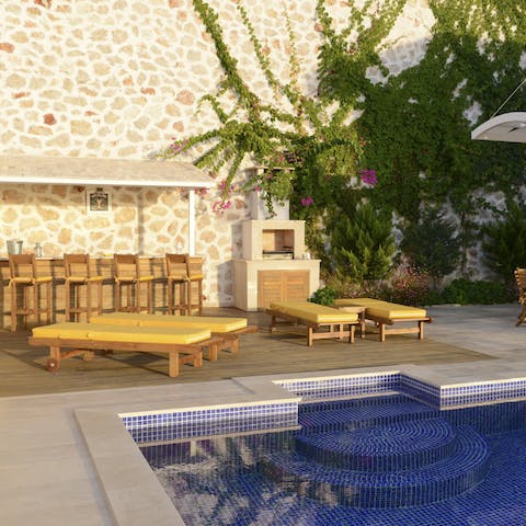 Step from the sun lounger into the beautifully tiled swimming pool