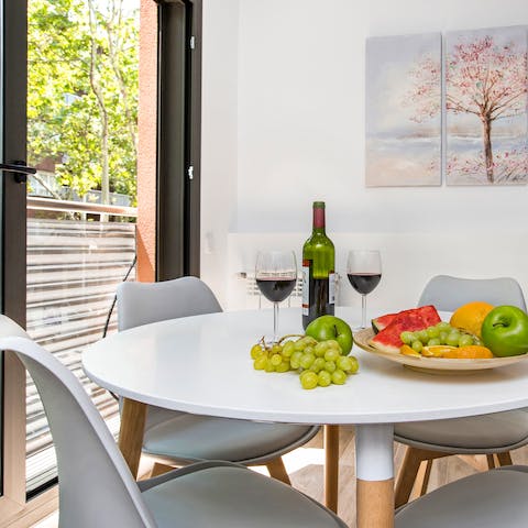 Gather around the modern dining table with a glass of tempranillo by the window
