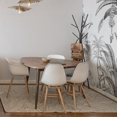 Admire the quirky palm-spangled wall paper behind the dining table
