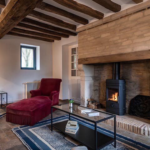 Kick back in the charming living room, reading a book by the fireplace