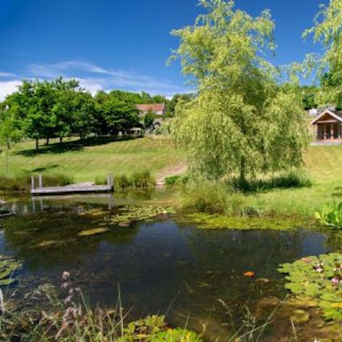 While away the hours in the sunshine by one of the two large ponds