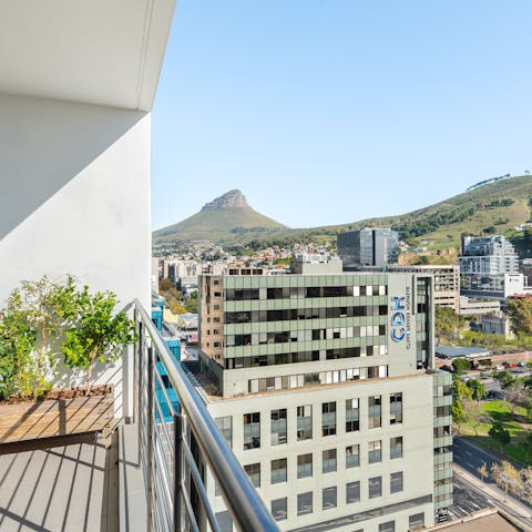 Take in the stunning views of the city and mountains from the balcony