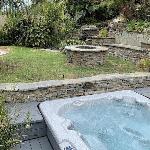 Relax in the hot tub after an active day of hiking at the Los Leones Trail, a six-minute drive away